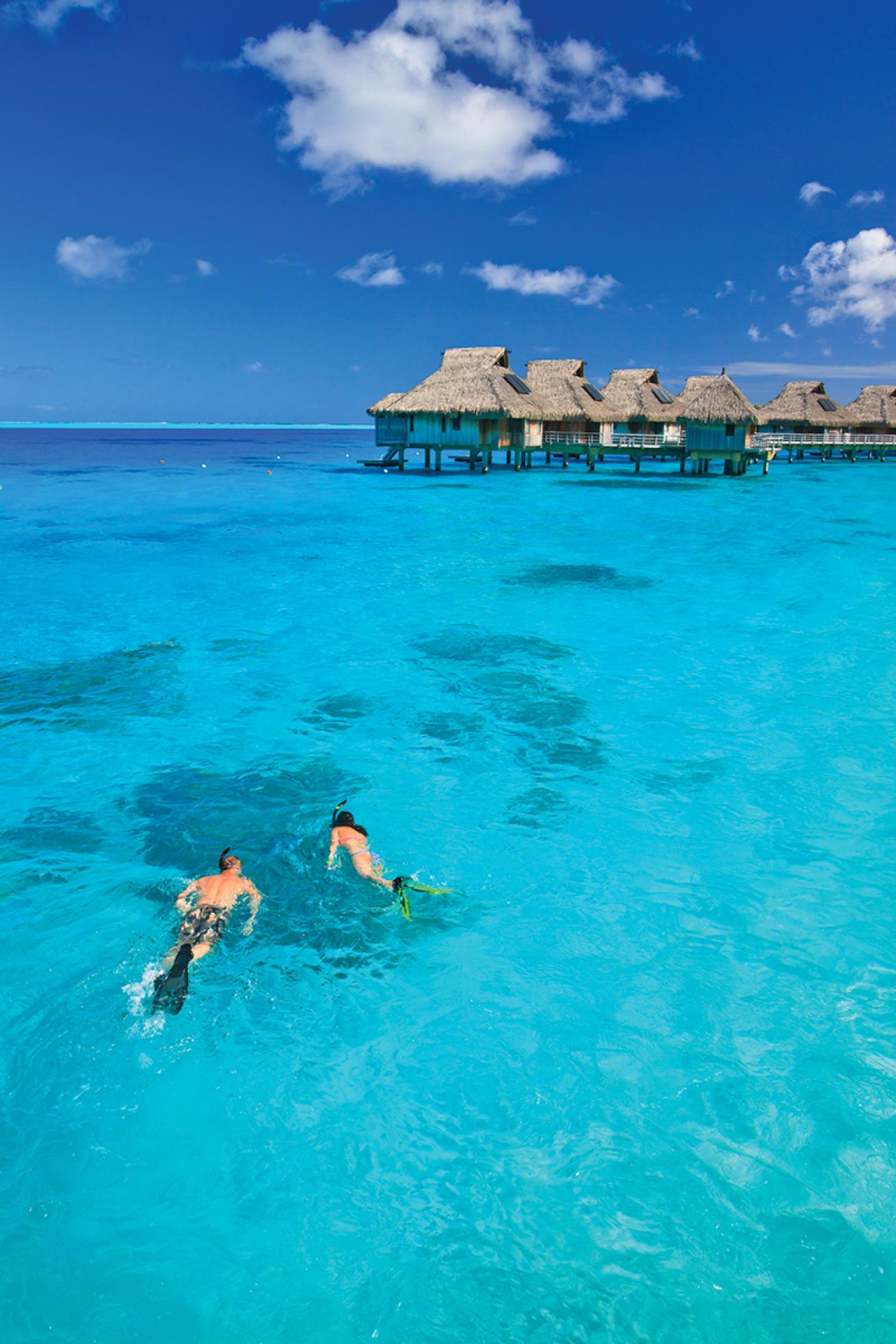 Couple snorkeling in French Polynesia