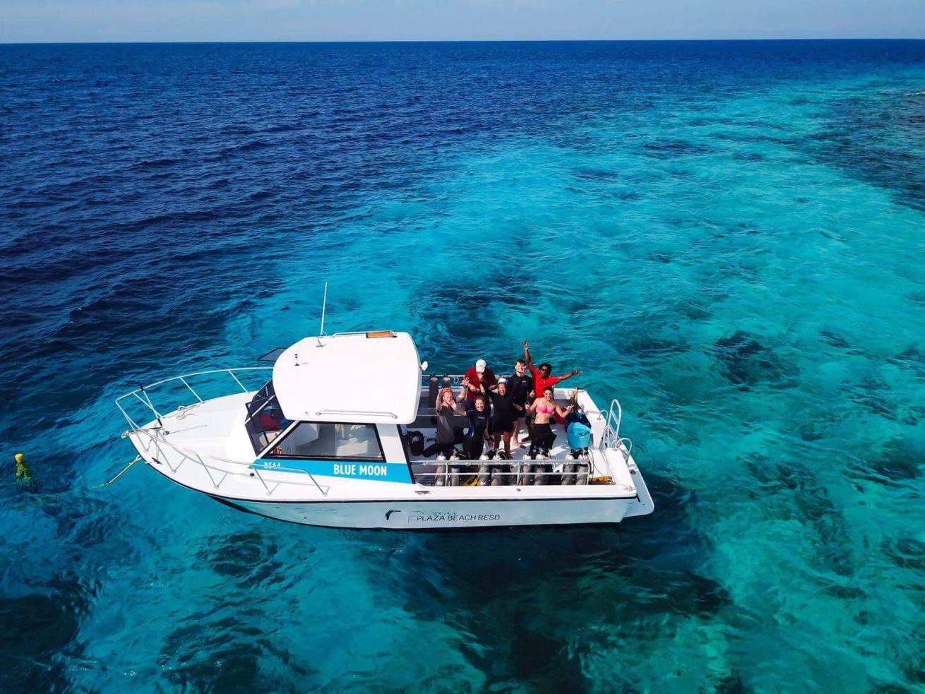 Boat at sea with scuba divers.