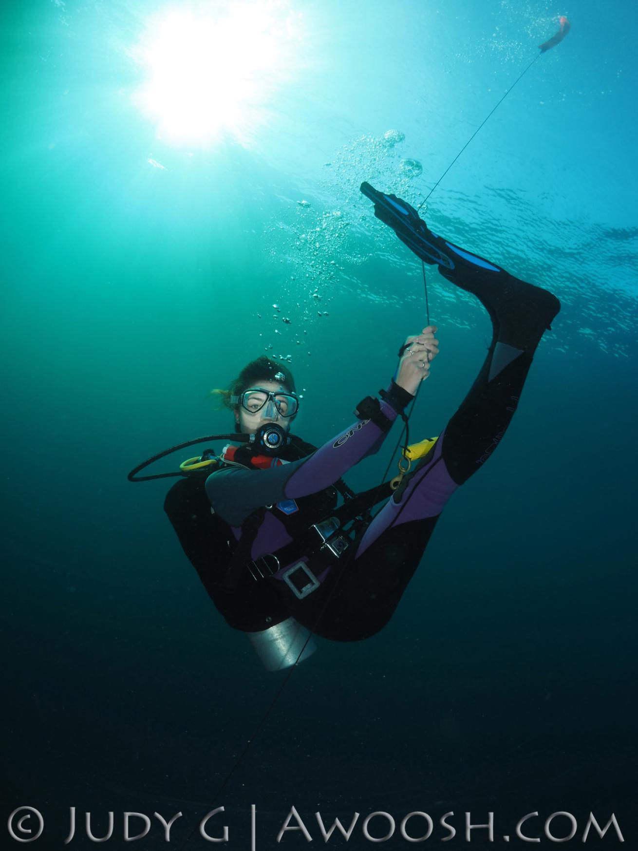 Scuba diver playing around on SMB line underwater in Thailand