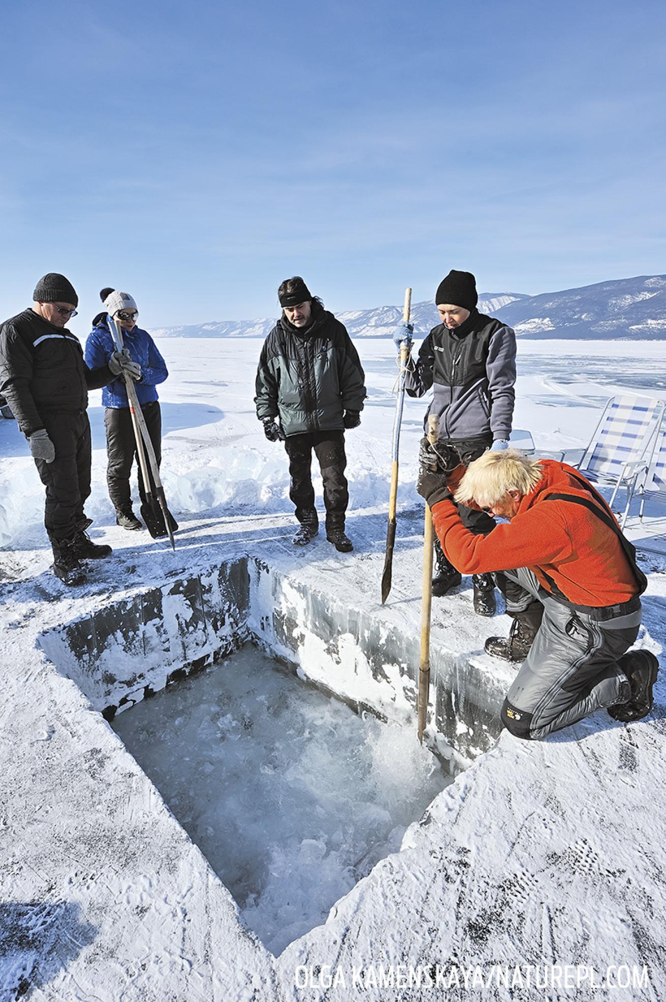 People Cutting Hole in Ice Scuba Diving