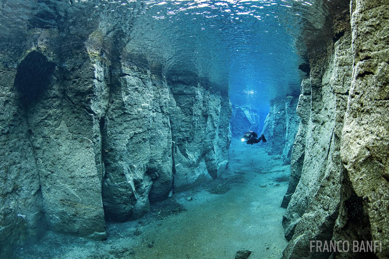 Scubadiver inside the volcanic crack Nesgjá Iceland