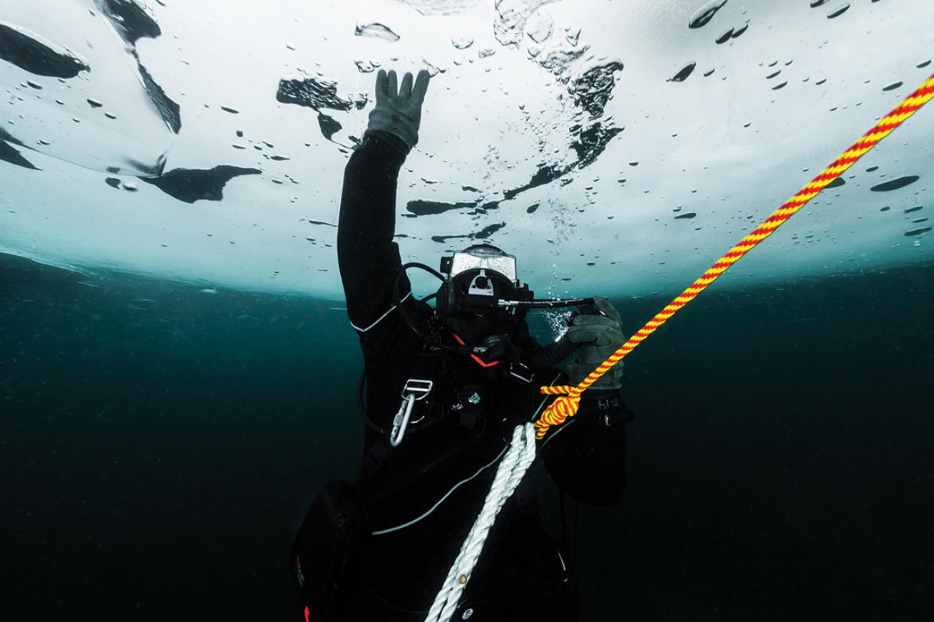 Diver below the ice of White Star Quarry