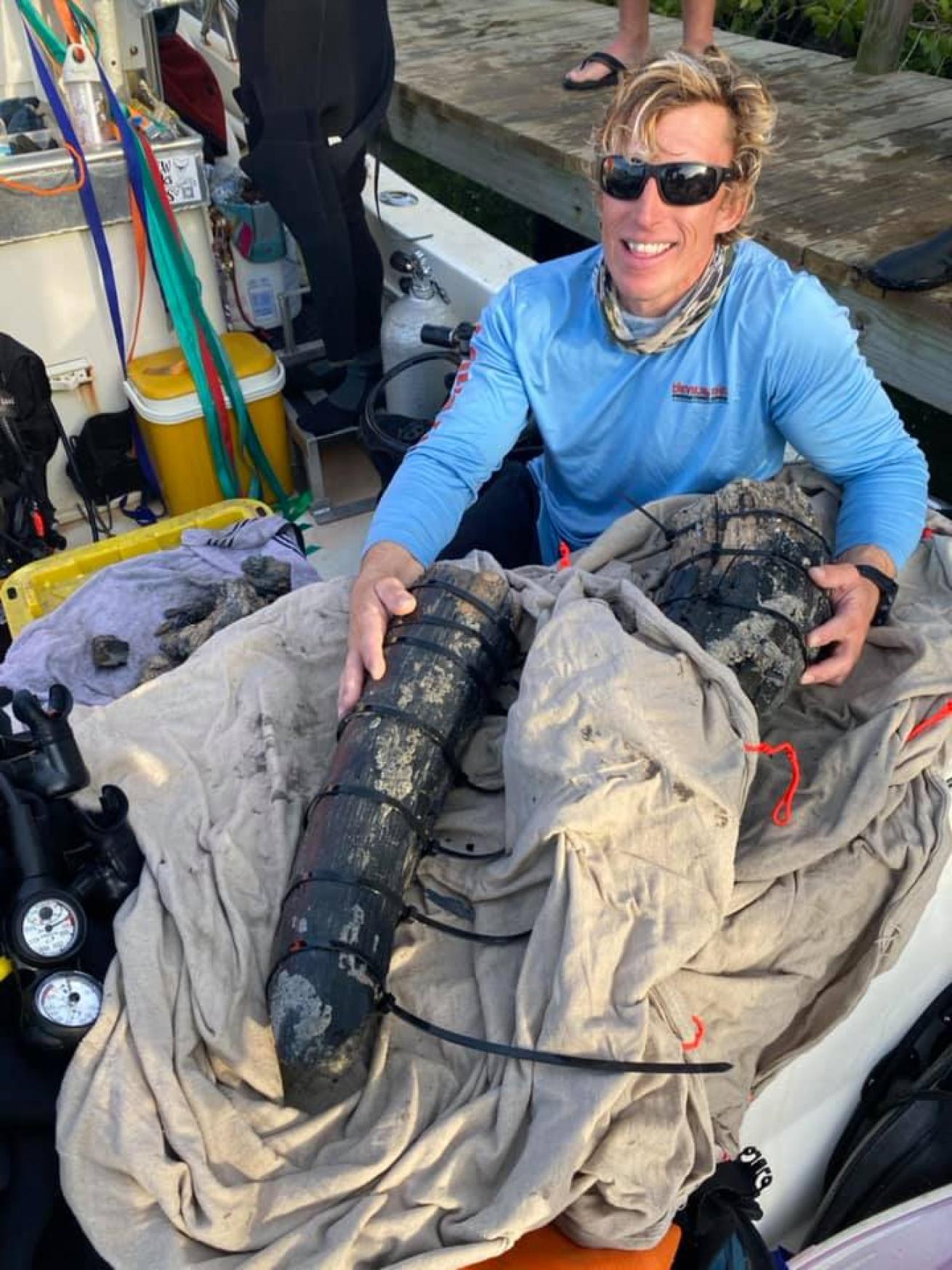 Diver poses with mammoth tusk discovered in Gulf of Mexico