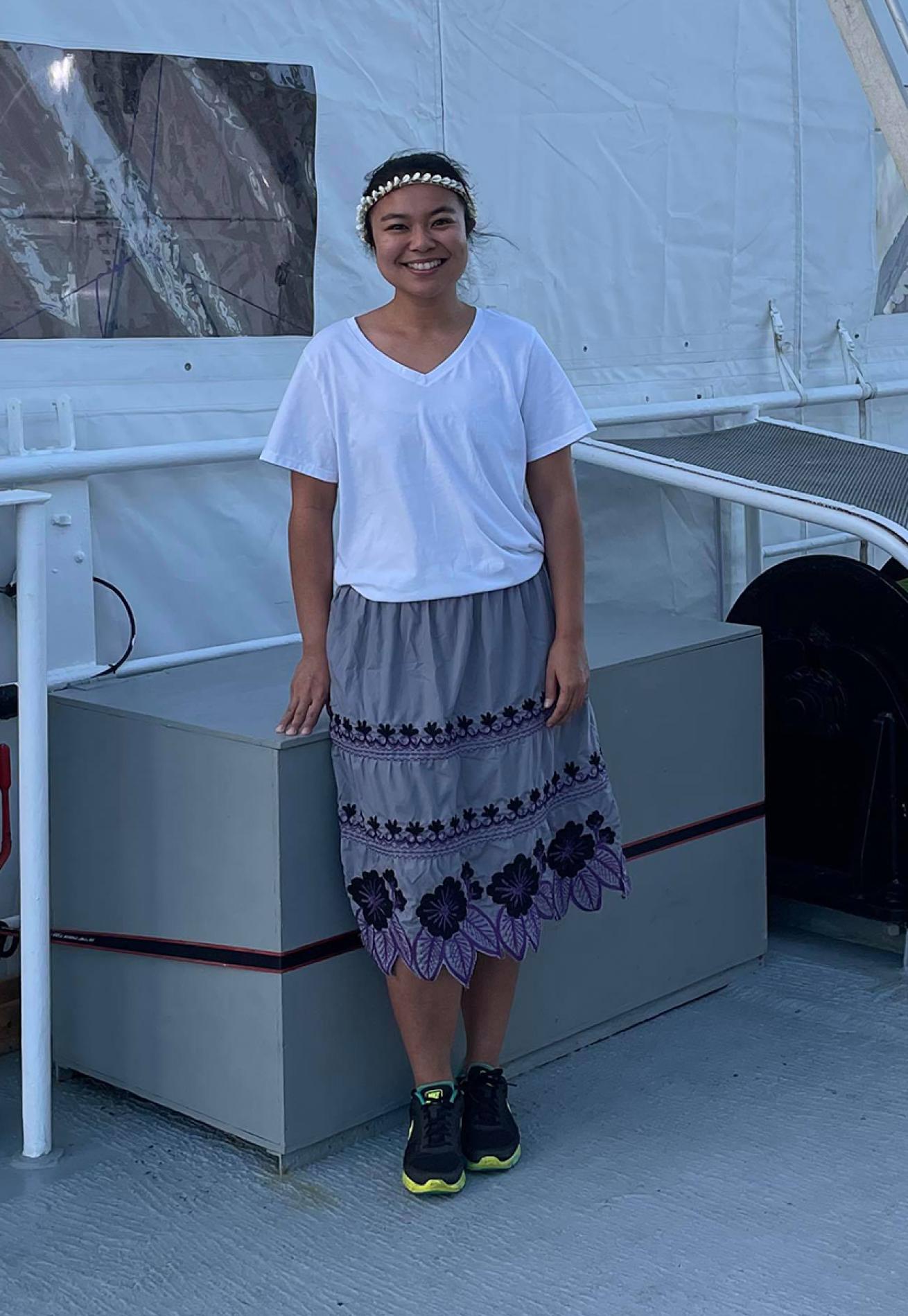 Yamase stands on the deck of the DSSV Pressure drop in her urohs and mwaramwar.