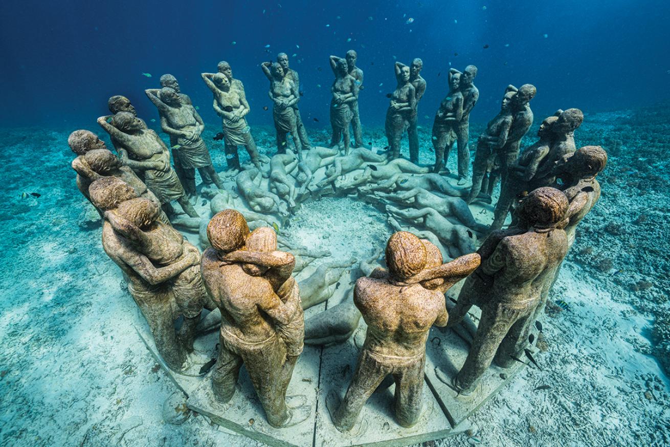 Fishes swim around figural statues stand in a circle 