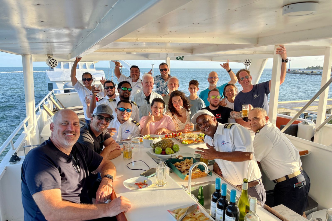 A group of people sitting around a bar on a boat