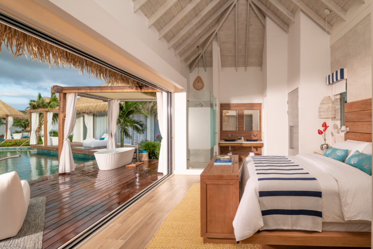 Bed overlooking a deck and pool