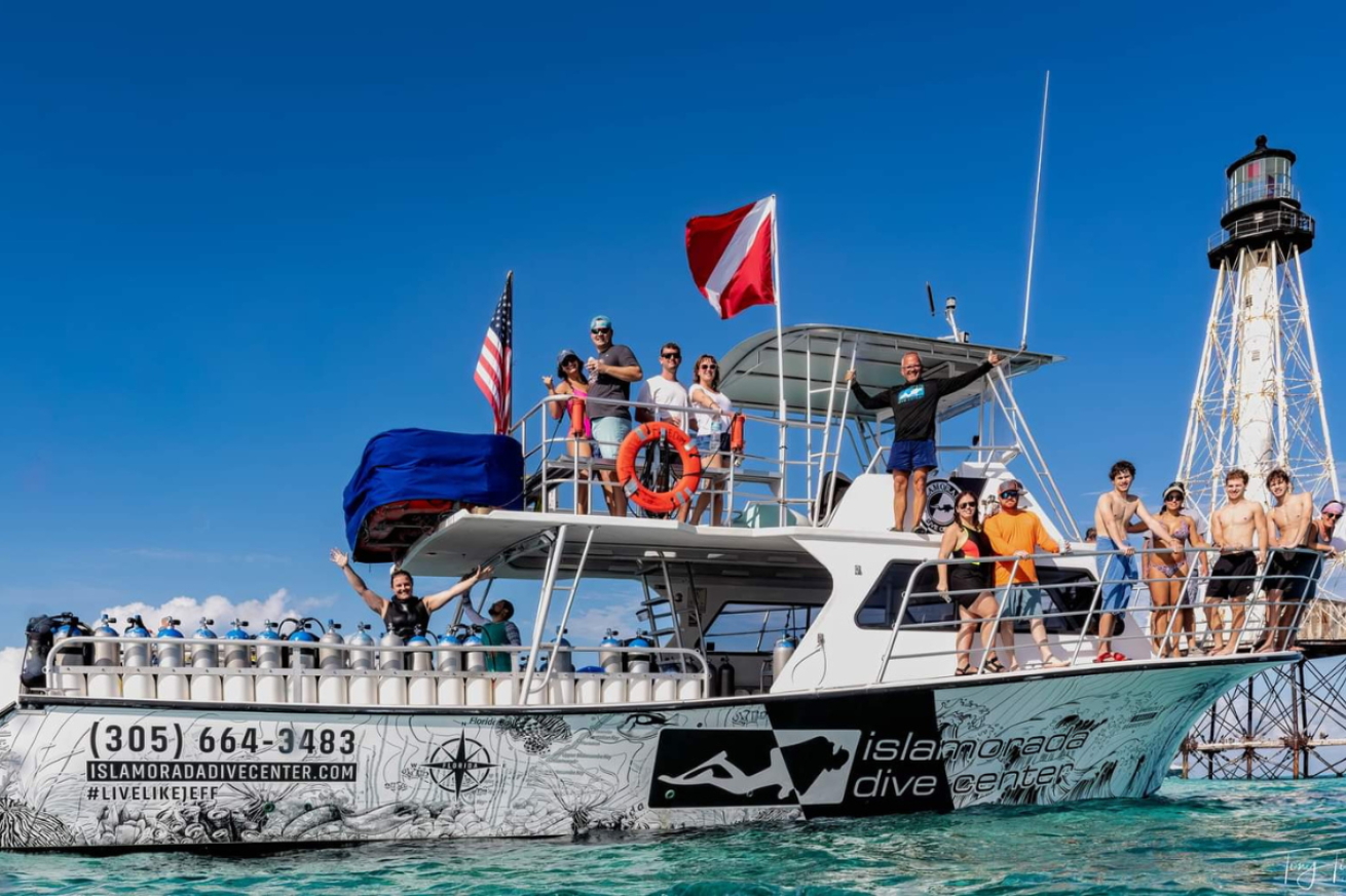 People standing on black and white boat