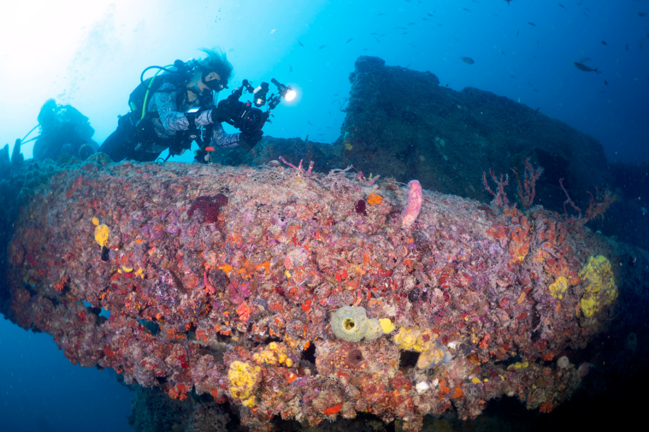 Scuba diver taking pictures of wreck