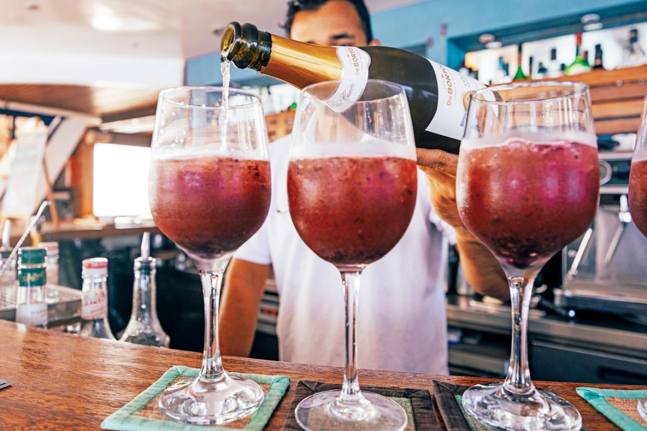 A bartender pours post-dive cocktails