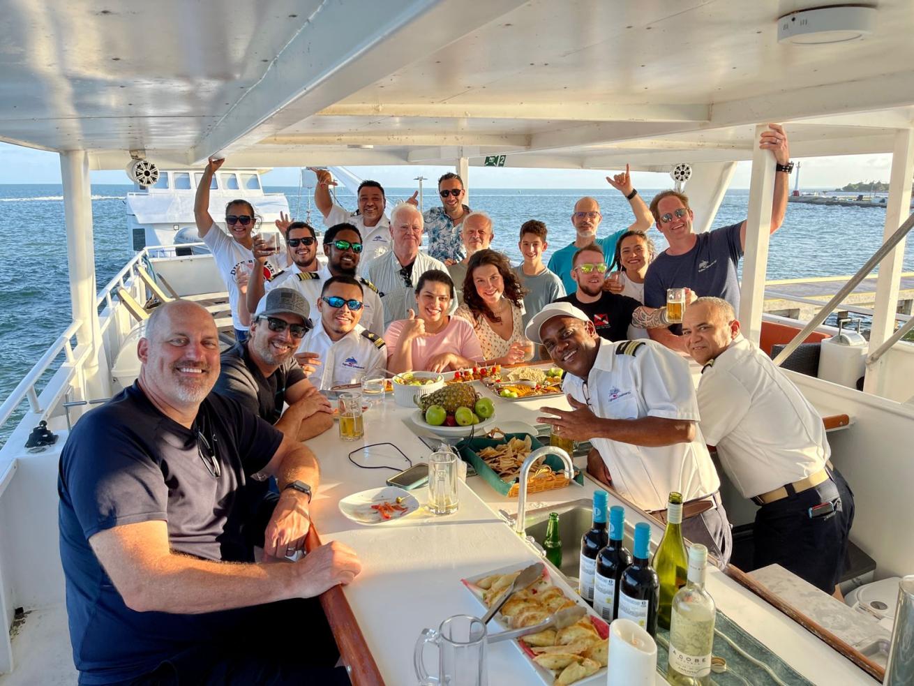 A group of people sitting around a bar on a boat