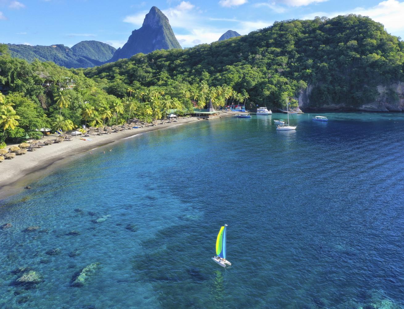 Sailboats close to beach shore