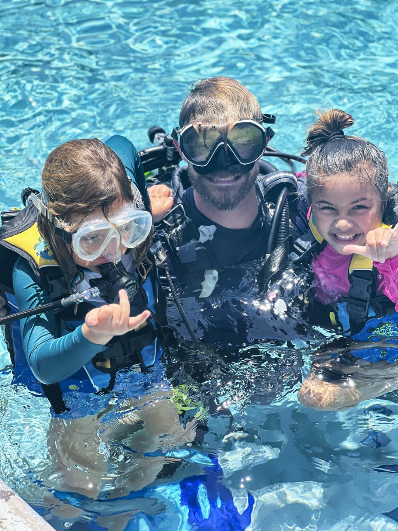 Like adults, kids get introduced to dive gear in the pool.