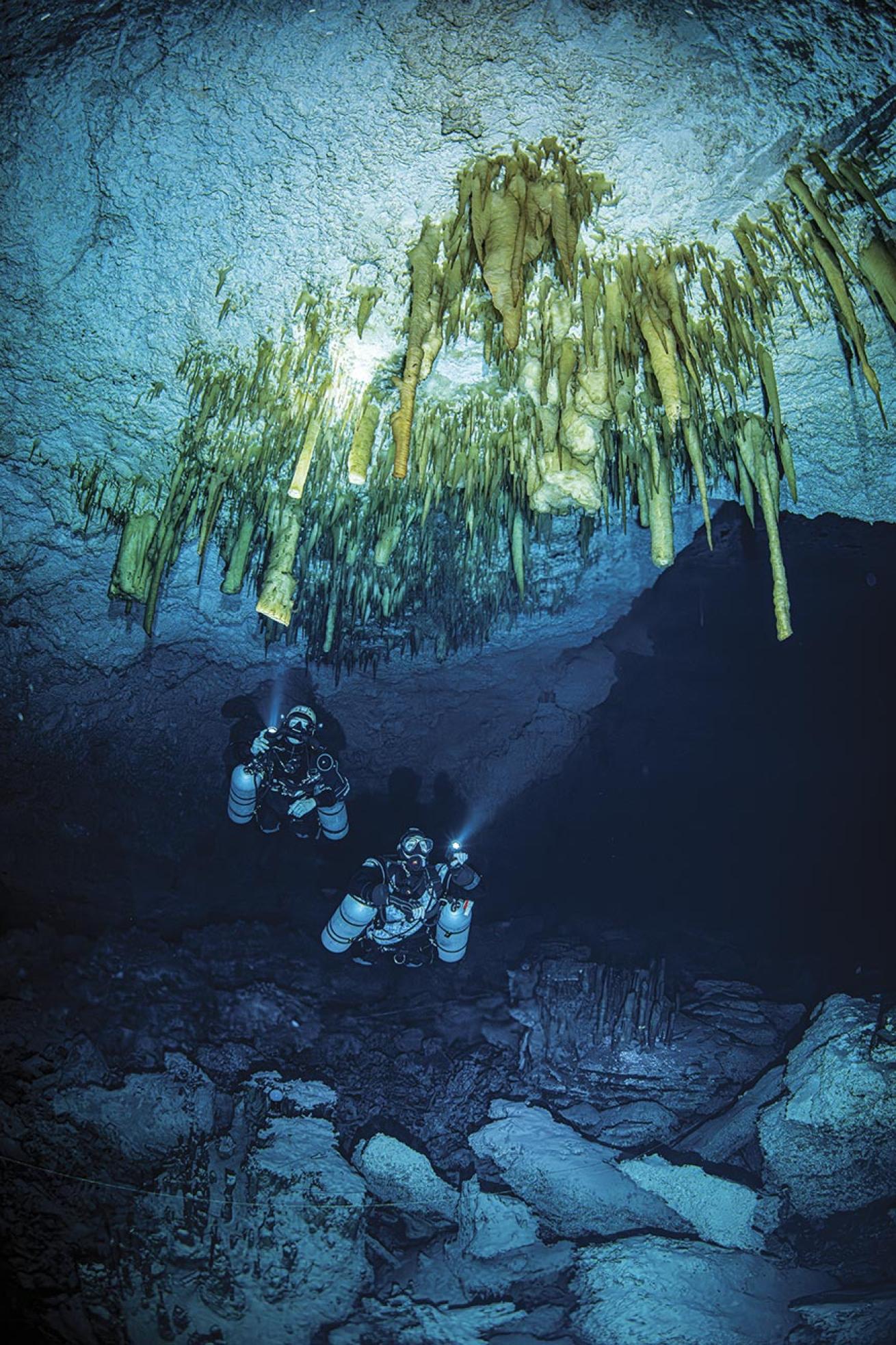 The author (right) and Zenato admire beautiful and delicate cave decorations that have accumulated over hundreds of years.