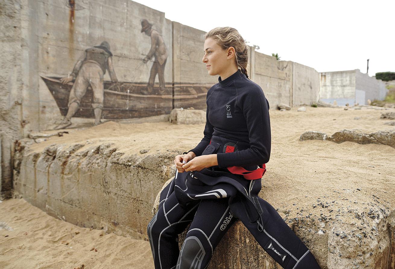 a female scuba diver in california on shore before a dive