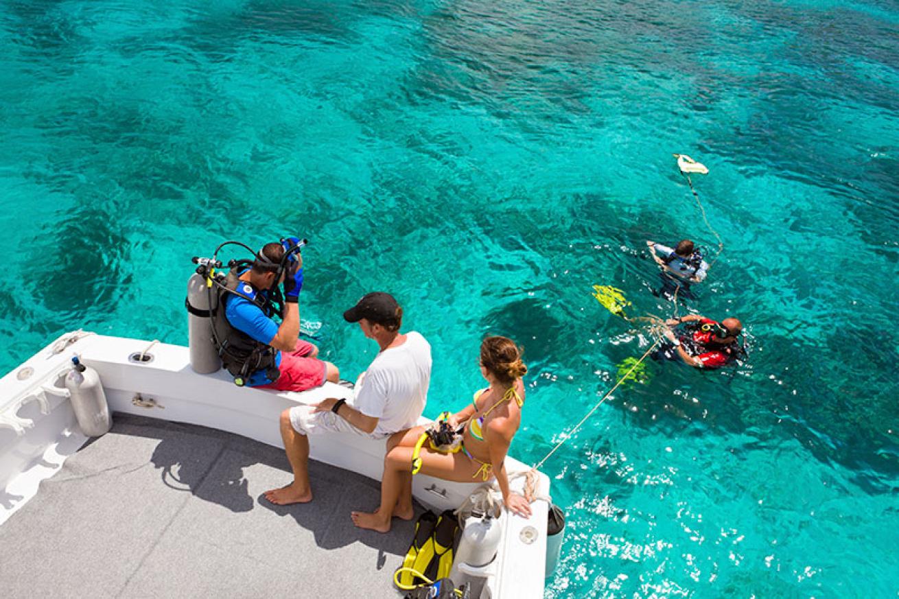 scuba divers entering the water