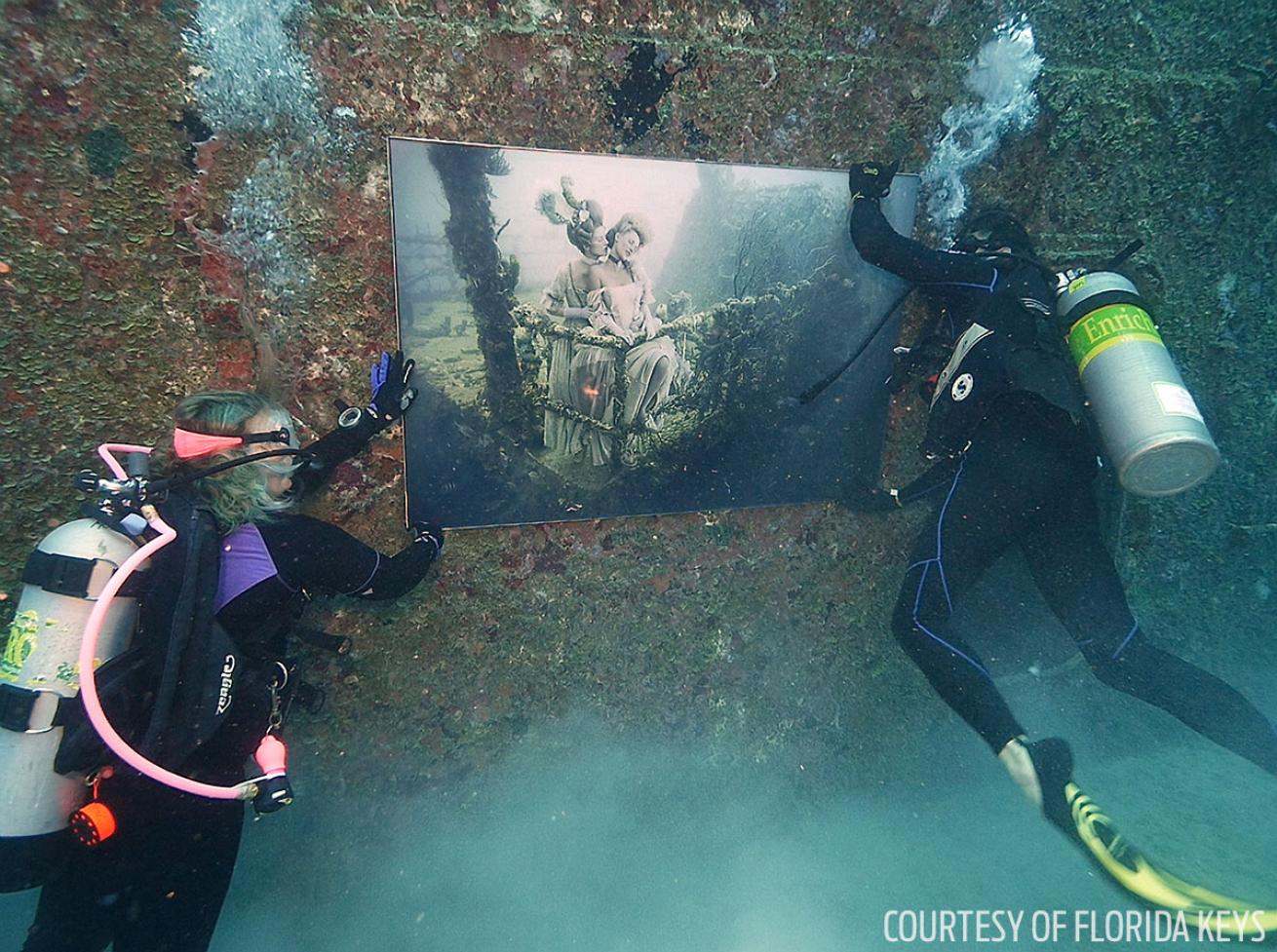 Scuba divers install art on the Vandenberg Key West