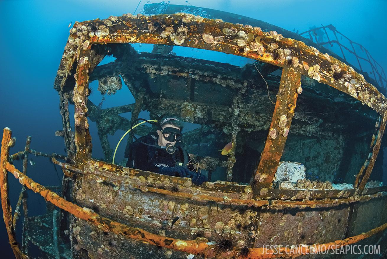 A diver explores inside the Oriskany