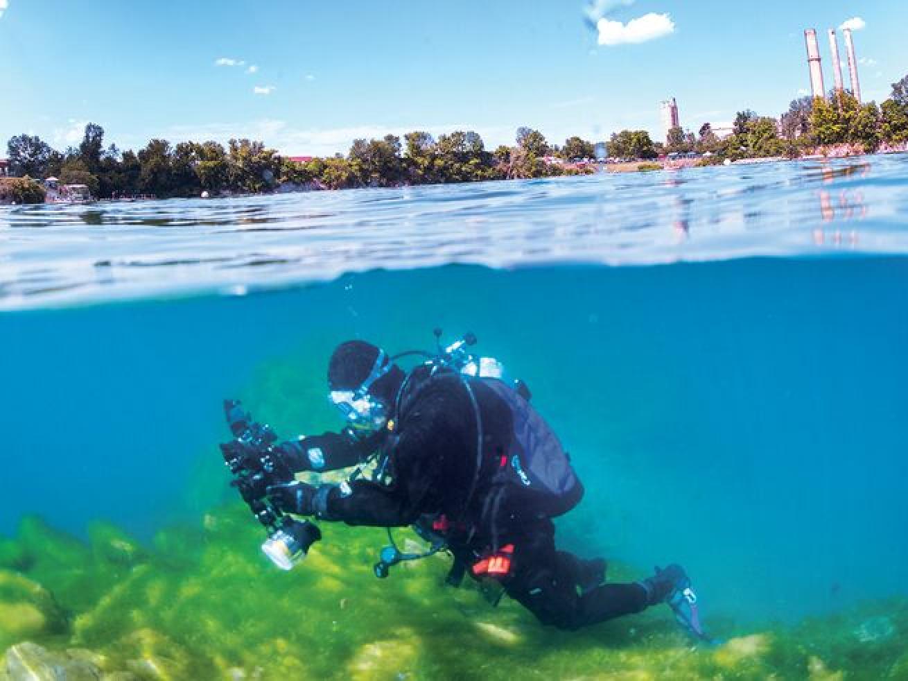 A photographer checks settings on a clear day while diving on “the island,” near the center of Dutch Springs.