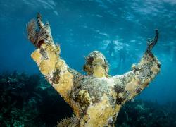 an underwater photo of the Christ of the Abyss