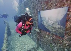 Diver inspects an underwater art gallery on the Vandenberg in Key West